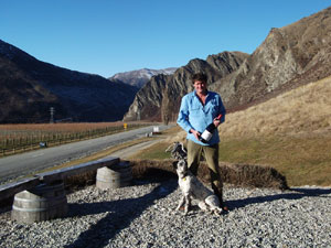 Jeremy Railton with ‘Chief' the dog at Mt Rosa Winery with Nevis Bluff in the background