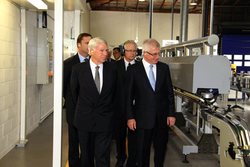 (From left) New Image general manager Guy Wills, chairman Graeme Clegg, production manager John Miller, and Trade Minister Tim Groser watch as the latest batch of freshly made cans roll along the line at the New Image Group Penrose plant in Auckland